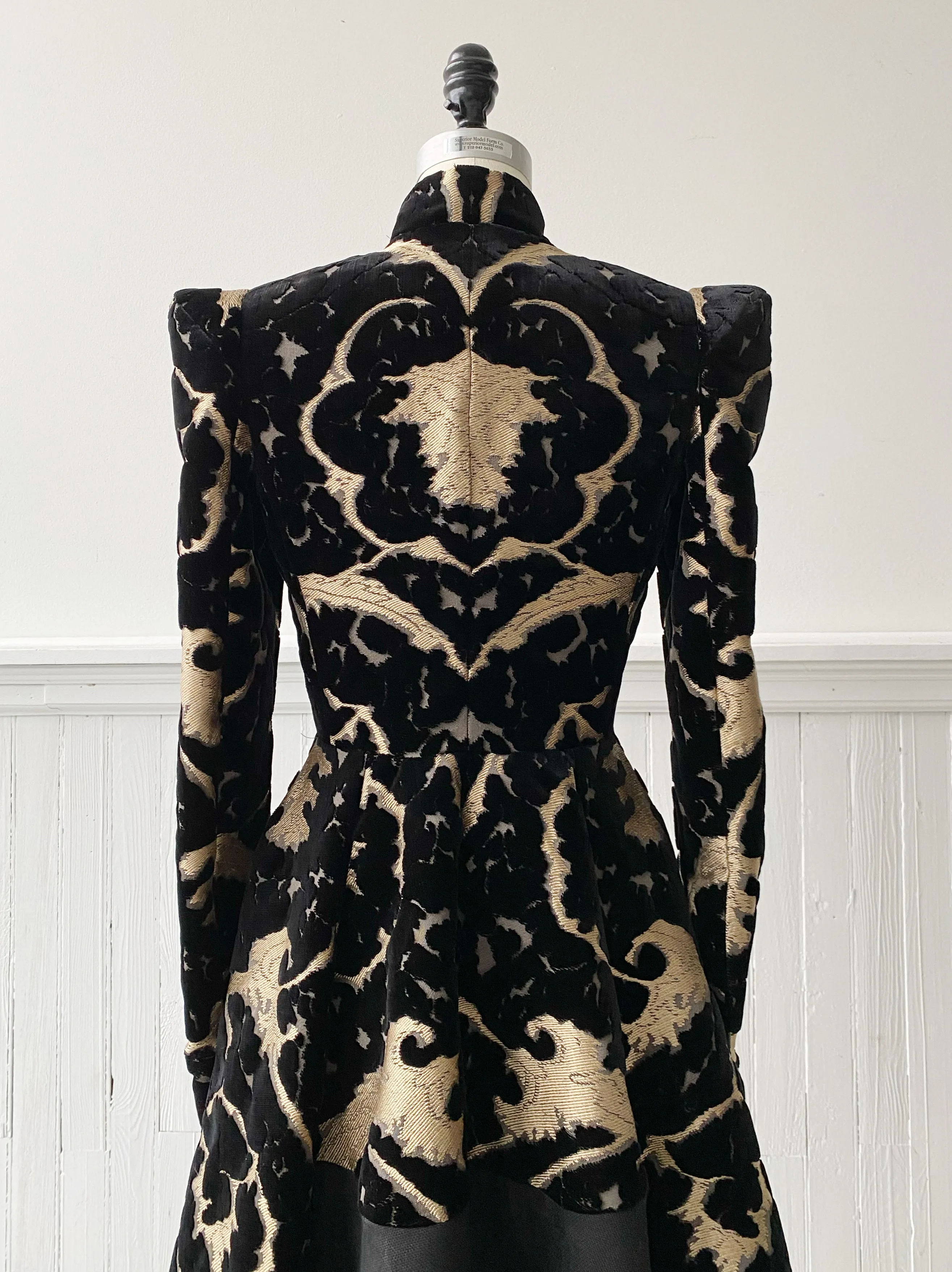 muse of capitalism coat