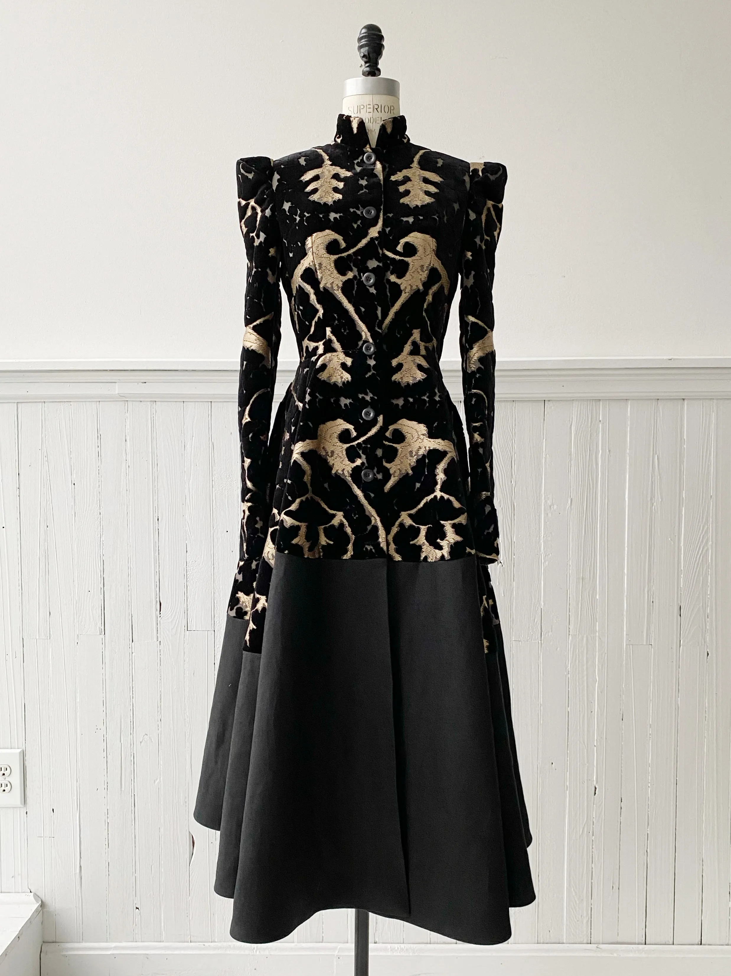 muse of capitalism coat